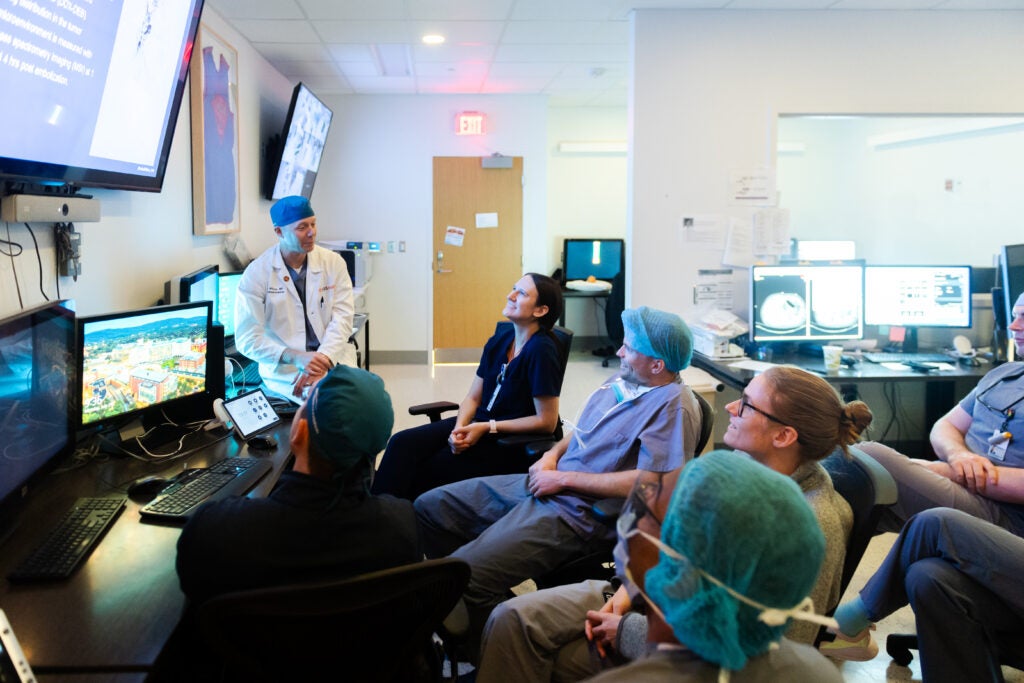 Dr. Luke Wilkins, MD gives a lecture to residents in UVA's IR reading room.
