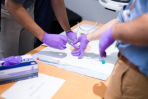 Close up of hands performing an IR procedure workshop
