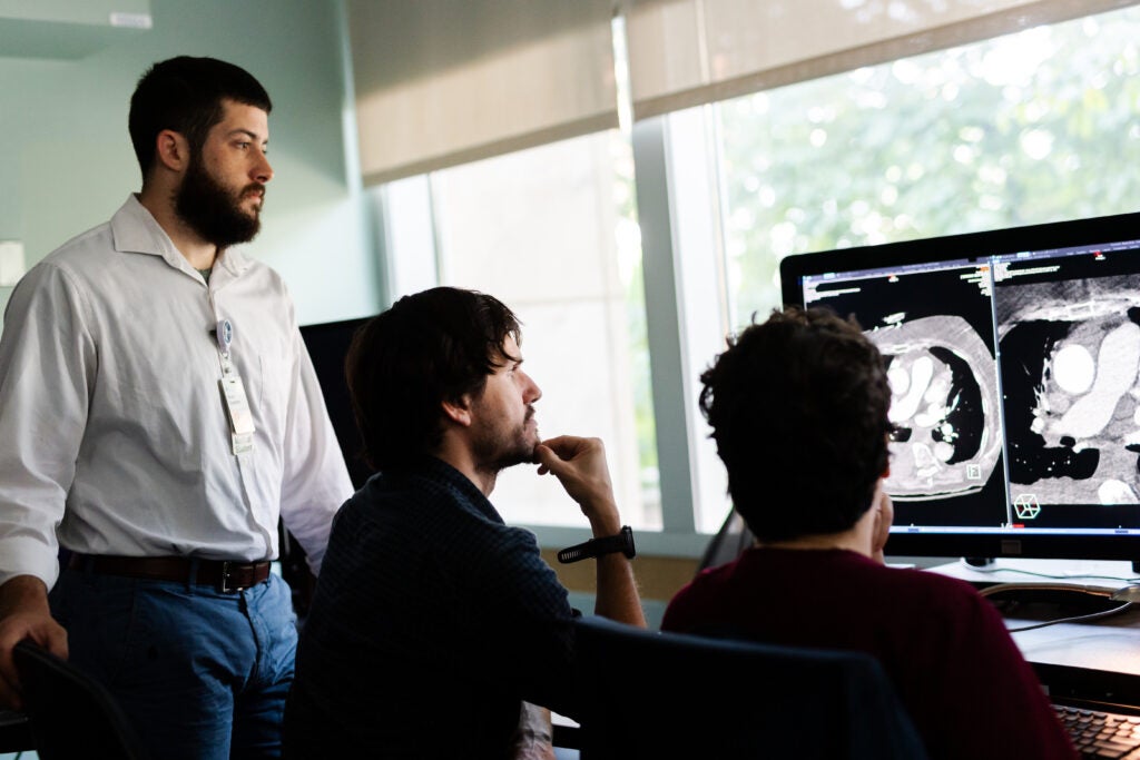 three trainees read a radiology scan on a computer