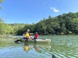 Ernie Wang and child in boat on lake