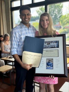 Vishnu Chandra, MD and Amy Taylor, MD stand with plaques & diplomas