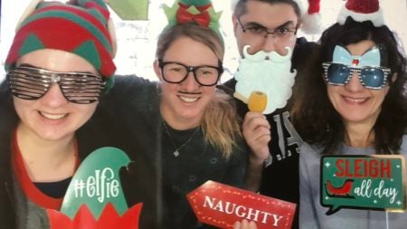 students celebrating Christmas in Santa Hats