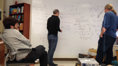 Professor teaching using a white board