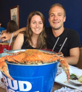 University of Virginia William Plautz, MD, Surgery Resident smiles with his wife Ester at a seafood restaurant.