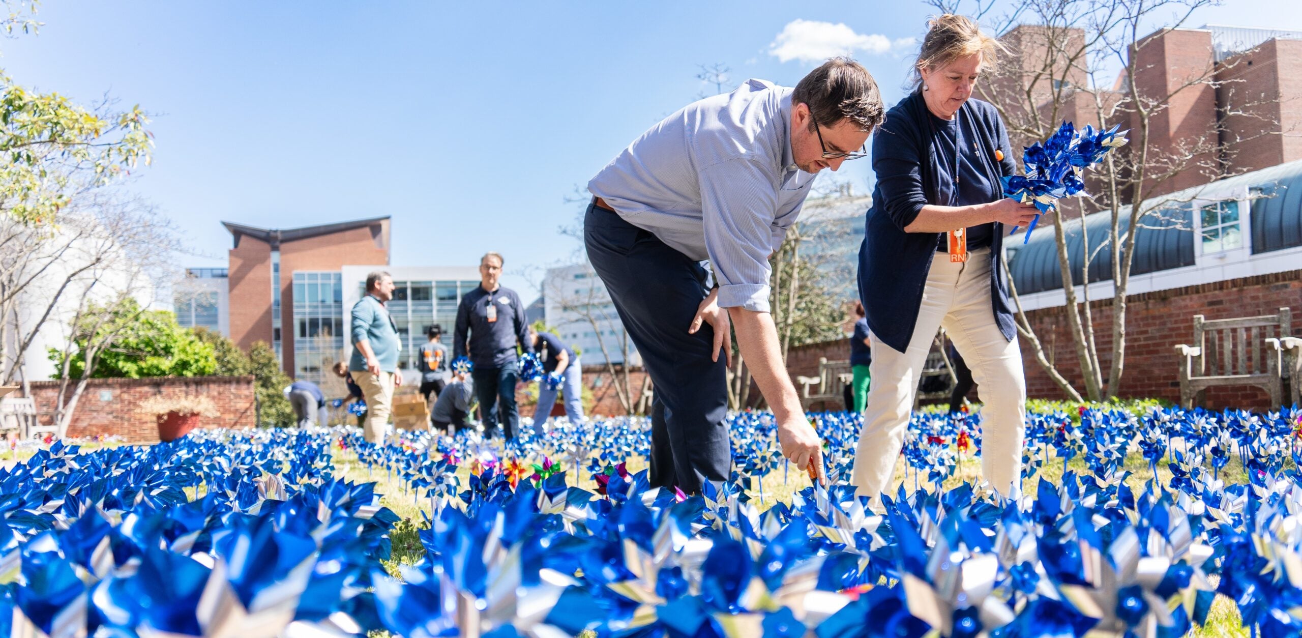 Transplant team members setting up a windmill garden during donate life month.