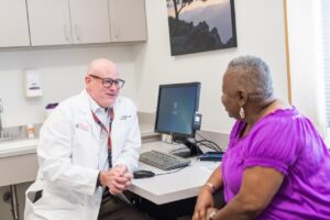 Program Director, Peter Hallowell, MD, speaking with a patient.