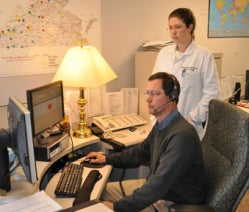 Photo of Scott Wiley and Dr. Jennifer Boyle talking on the poison center hotline.