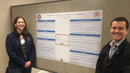 Doctors Borek and Rizer stand by presentation poster