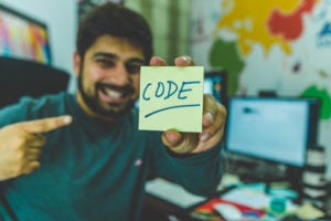 guy holding up sticky not that says code
