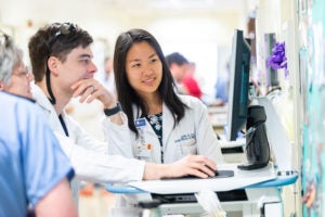 Dermatology residents studying a case.