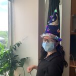 A women from the lab wearing a wizard hat